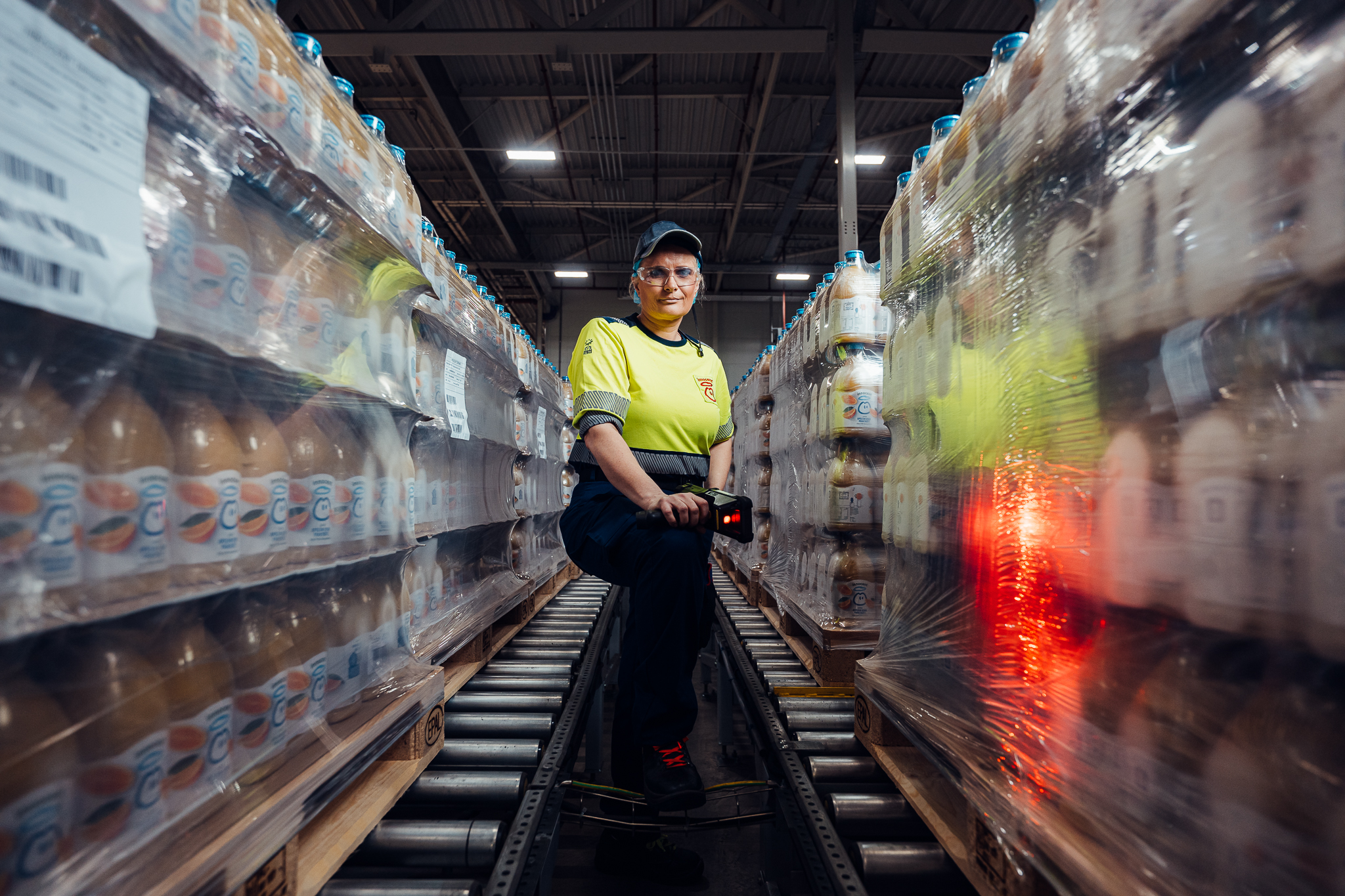 Person with scanner in a warehouse full of products.