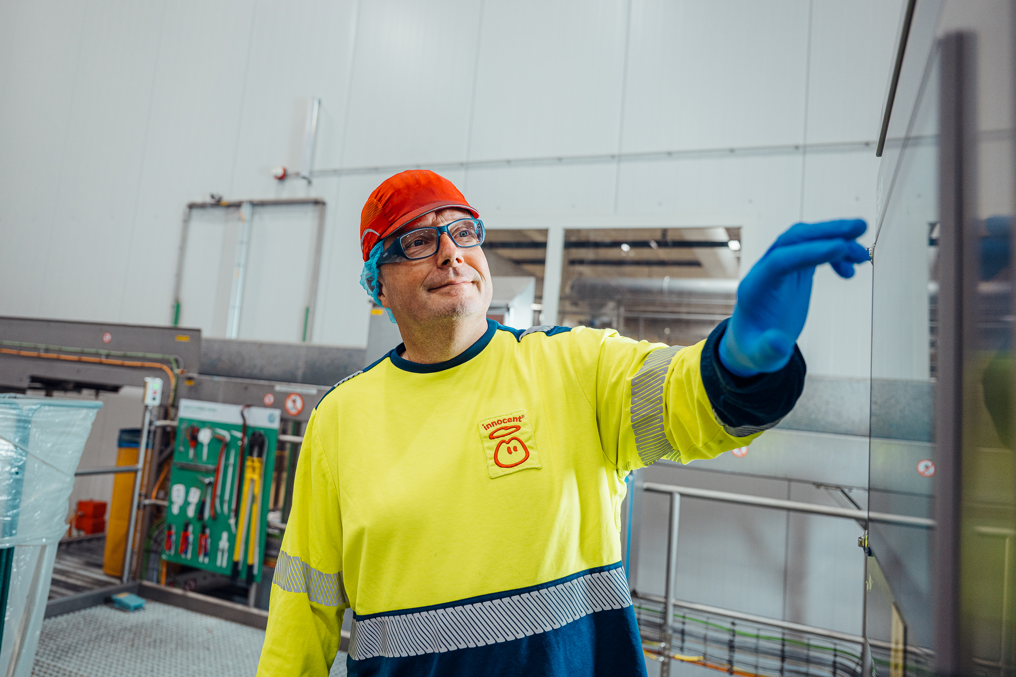 Man wearing safety gear working in a factory.